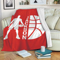 Red basketball throw blanket draped over a sofa with a player silhouette and bold basketball artwork