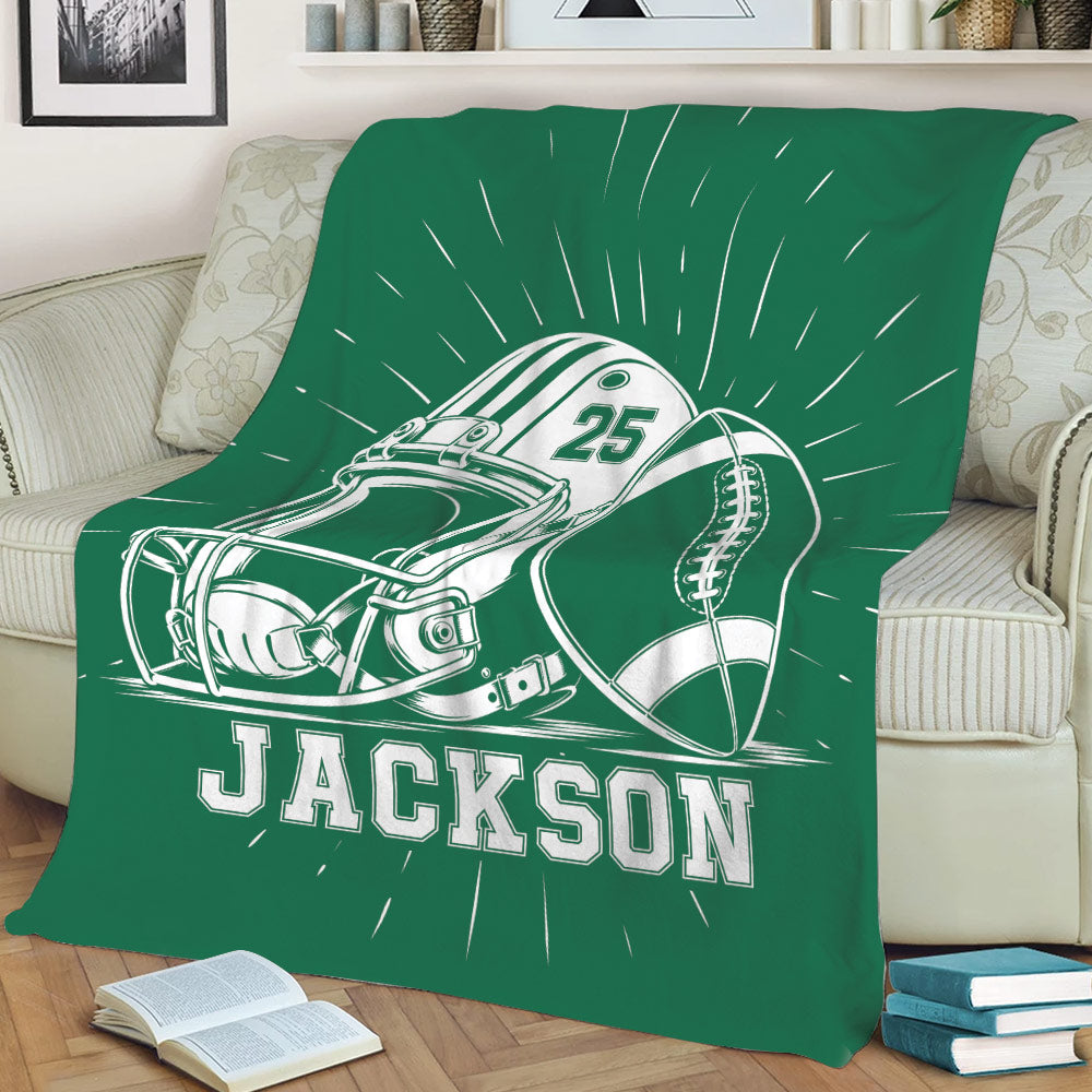 Green football throw blanket draped over a sofa with helmet and football design