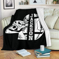 Black football blanket styled on a sofa with a helmeted player and football graphic