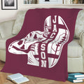 Maroon football blanket draped over a sofa with bold player and football artwork