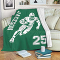 Green football throw blanket draped over a sofa with running player artwork and bold sports graphics