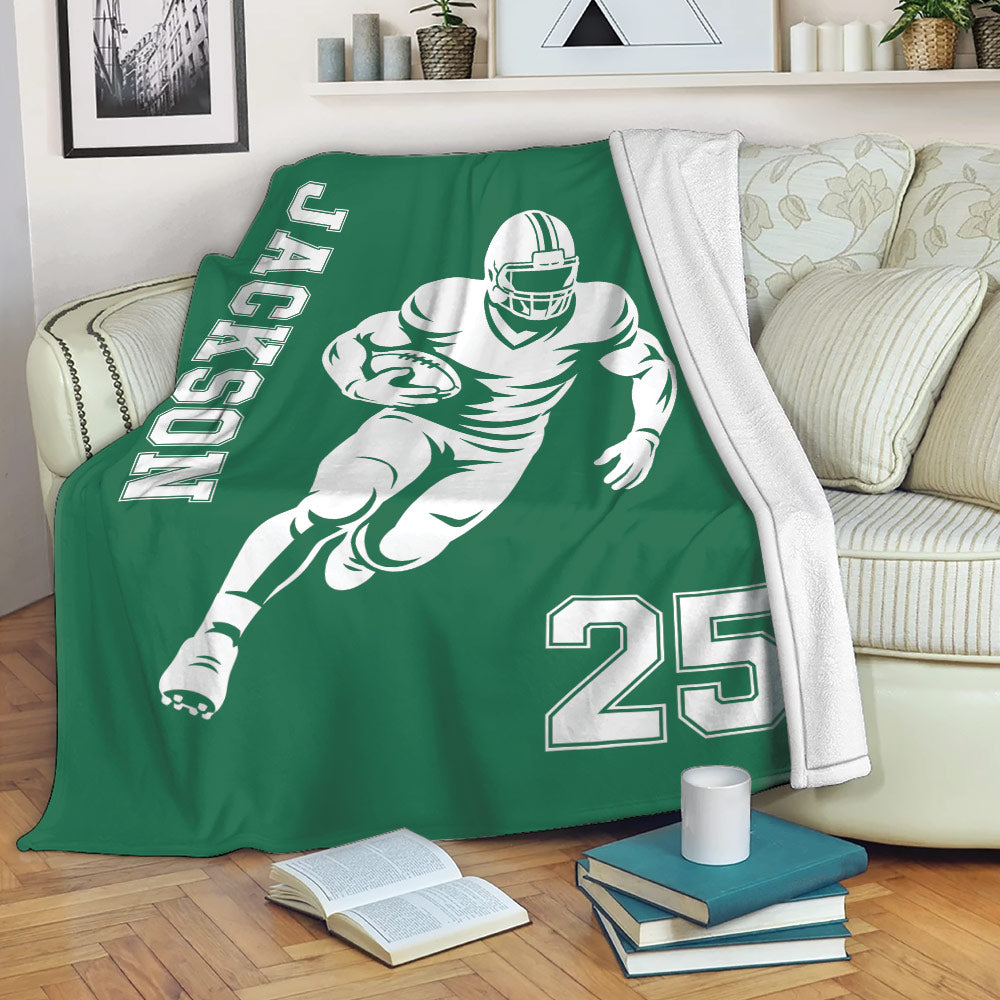 Green football throw blanket draped over a sofa with running player artwork and bold sports graphics