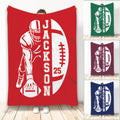 Football throw blanket featuring a helmeted player silhouette and oversized football graphic in multiple colors