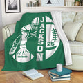 Green football throw blanket displayed on a sofa with helmeted player and football artwork