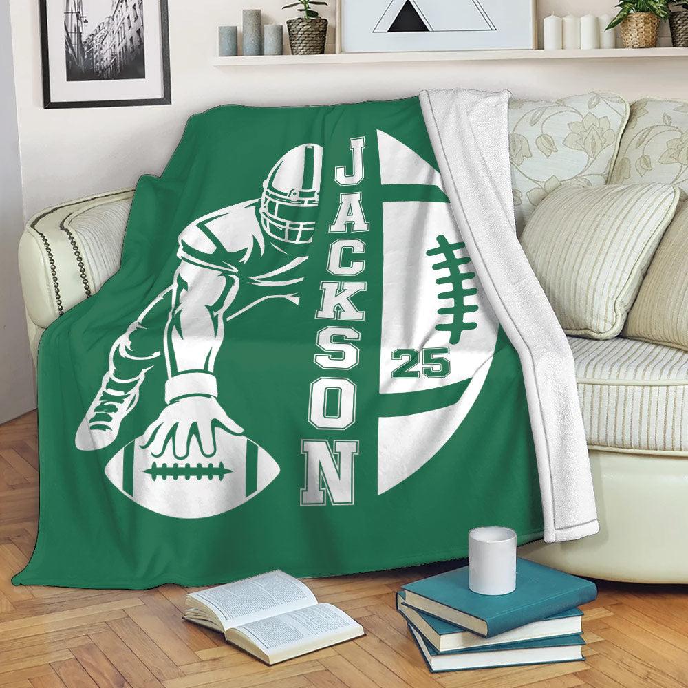 Green football throw blanket displayed on a sofa with helmeted player and football artwork