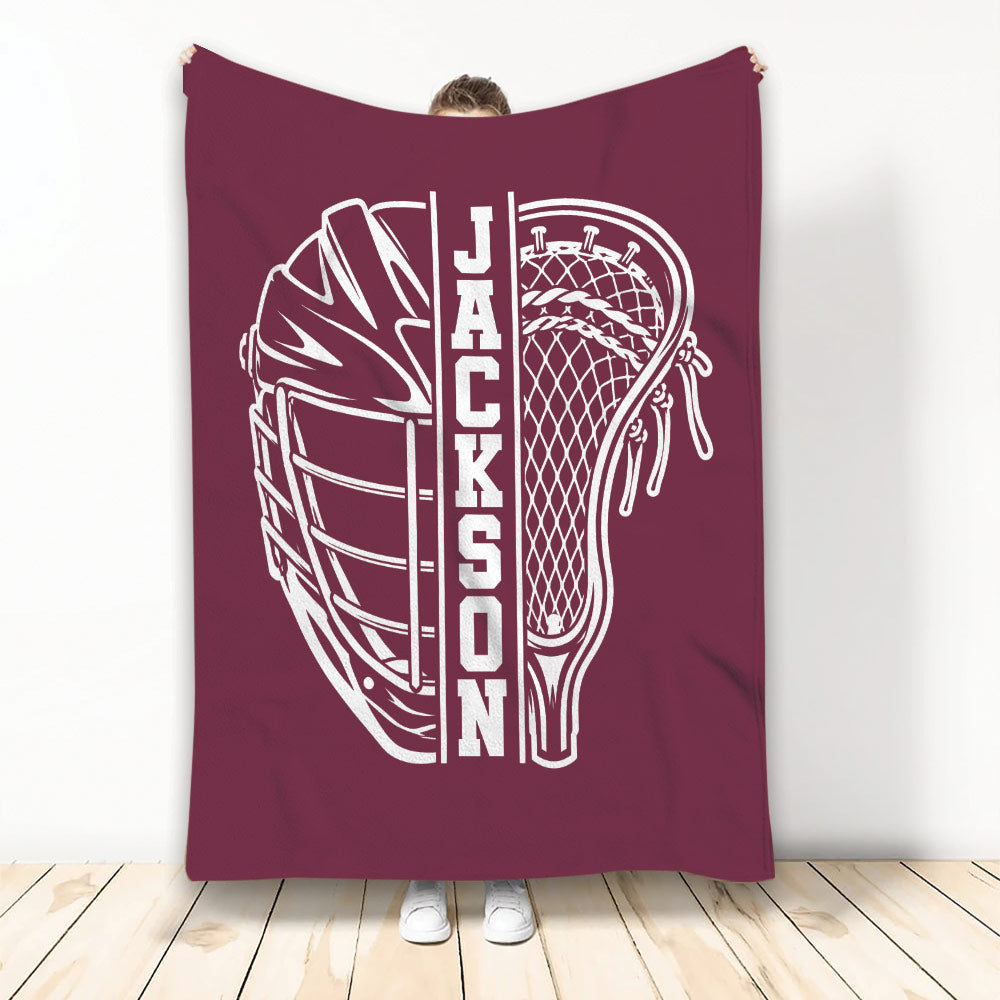 Maroon lacrosse throw blanket displaying a large white helmet and lacrosse stick illustration