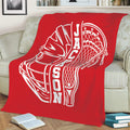 Red lacrosse blanket styled on a couch with an oversized white helmet and stick graphic