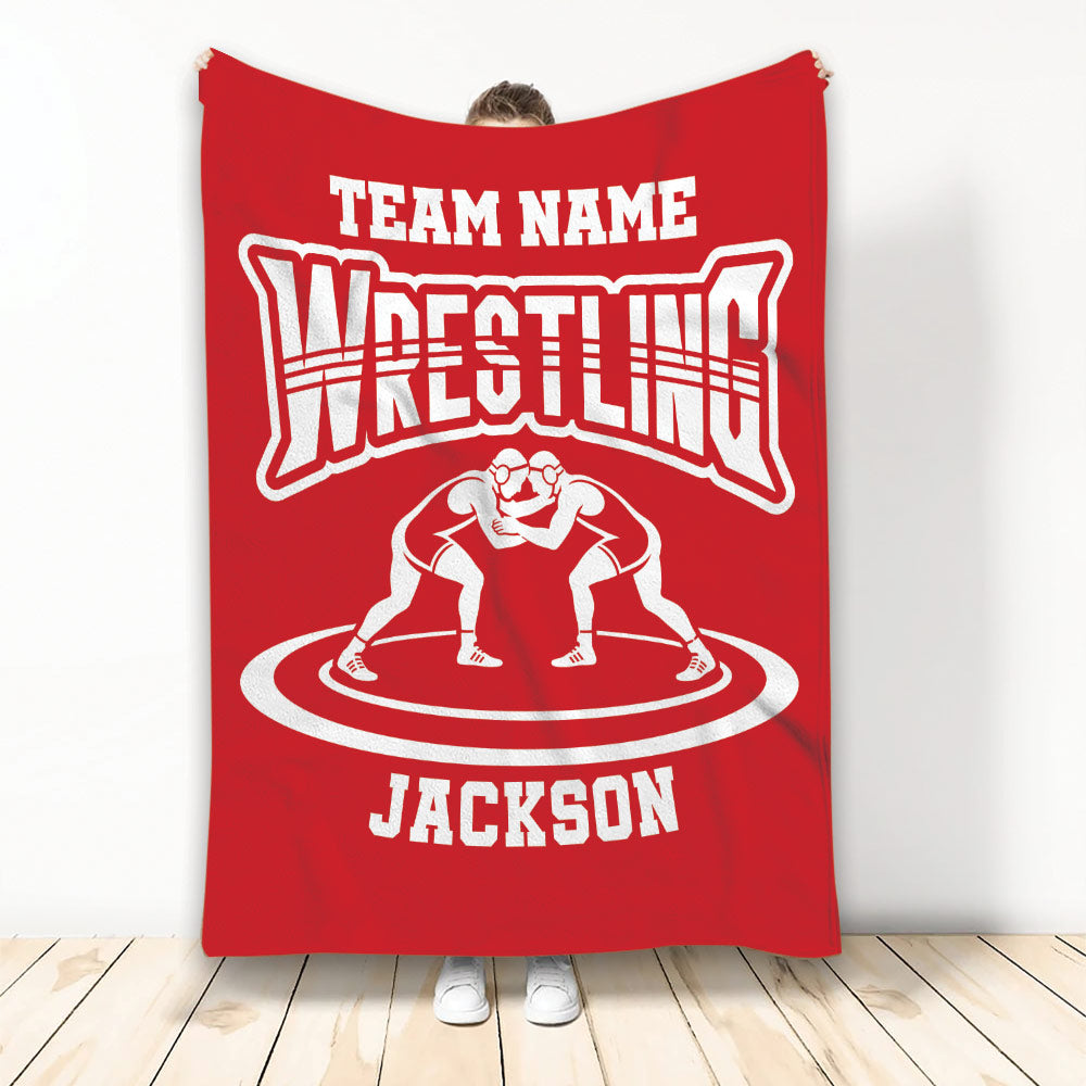 Red wrestling throw blanket displayed with two wrestlers on a circular mat design