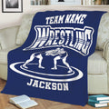 Navy wrestling blanket spread across a sofa with wrestling artwork and bold white graphics