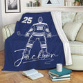 Blue hockey throw blanket draped over a sofa, featuring a skater illustration and bold sports artwork