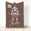 Brown hockey blanket displaying a detailed ice hockey player illustration in contrasting white artwork