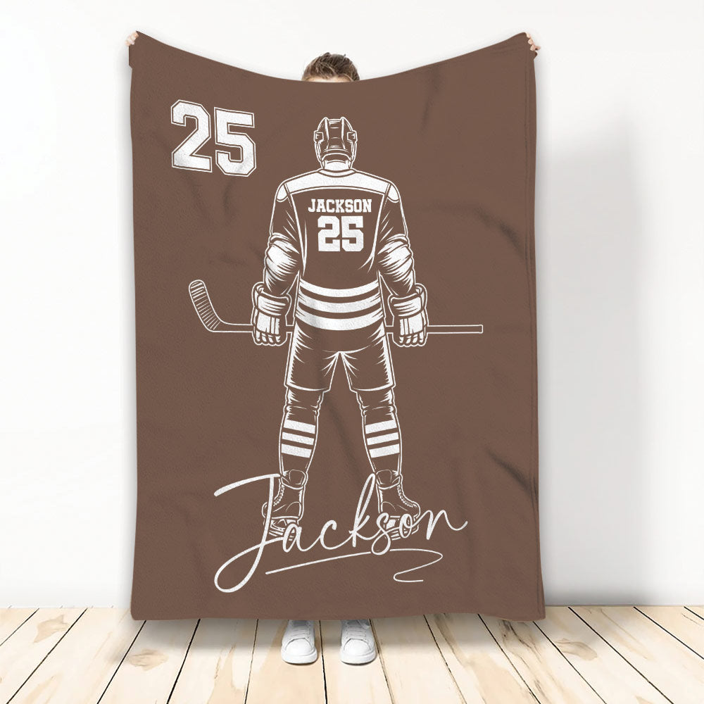 Brown hockey blanket displaying a detailed ice hockey player illustration in contrasting white artwork