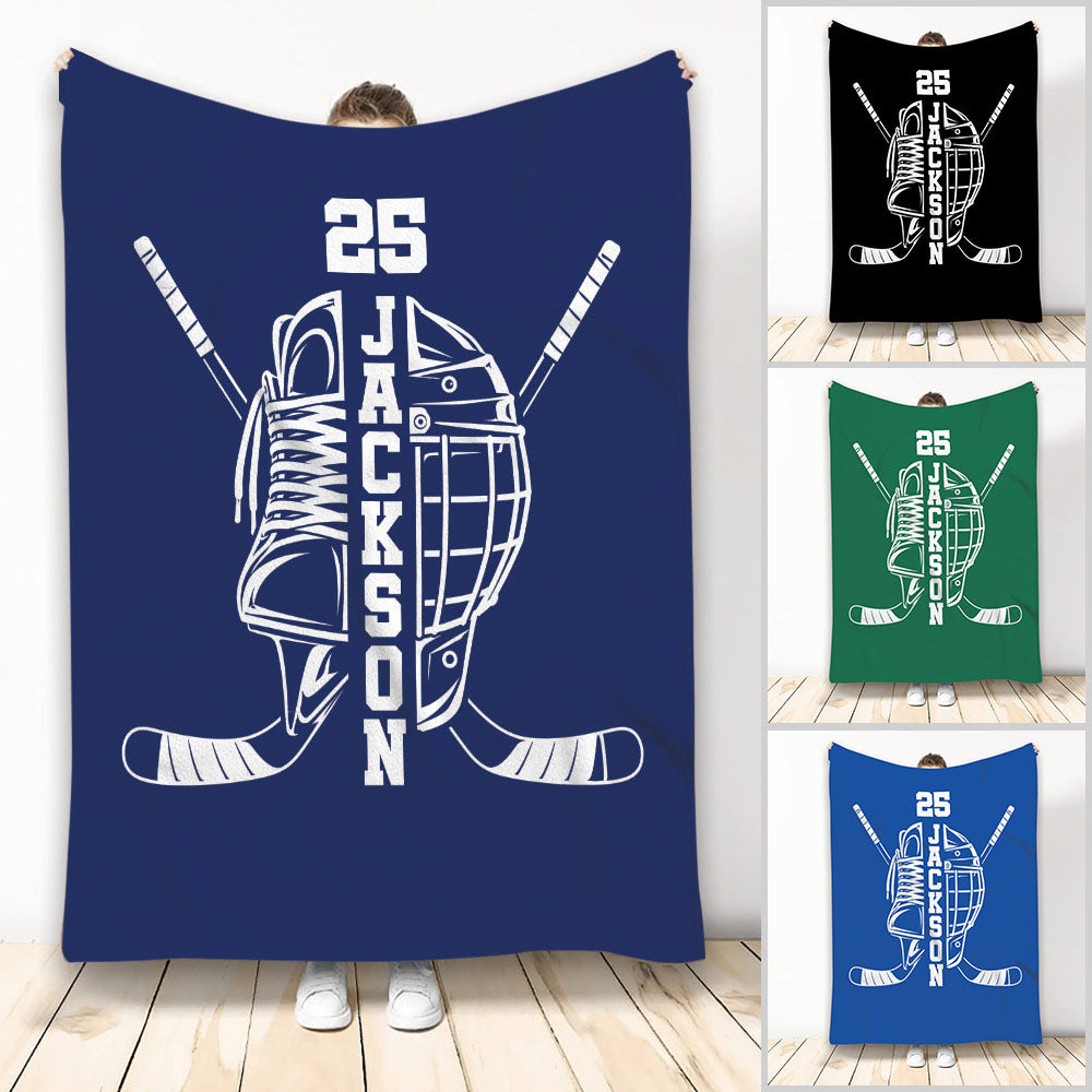 Blue hockey throw blanket with crossed sticks, skate, helmet, and bold monochrome sports artwork