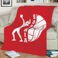 Red volleyball blanket displayed on a sofa with a white diving player silhouette and volleyball artwork