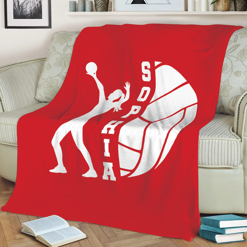 Red volleyball blanket displayed on a sofa with a white diving player silhouette and volleyball artwork