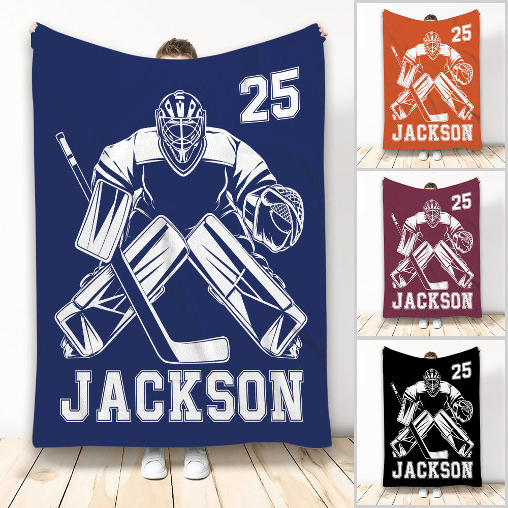 Hockey goalie throw blanket shown in navy with bold athletic artwork and multiple color examples