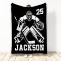 Black hockey throw blanket featuring a bold white goalie illustration and athletic sports theme