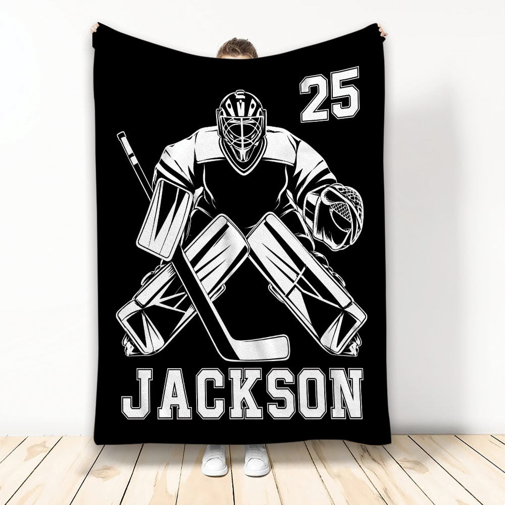 Black hockey throw blanket featuring a bold white goalie illustration and athletic sports theme