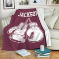 Boxing throw blanket draped over a sofa with illustrated gloves and bold sports artwork
