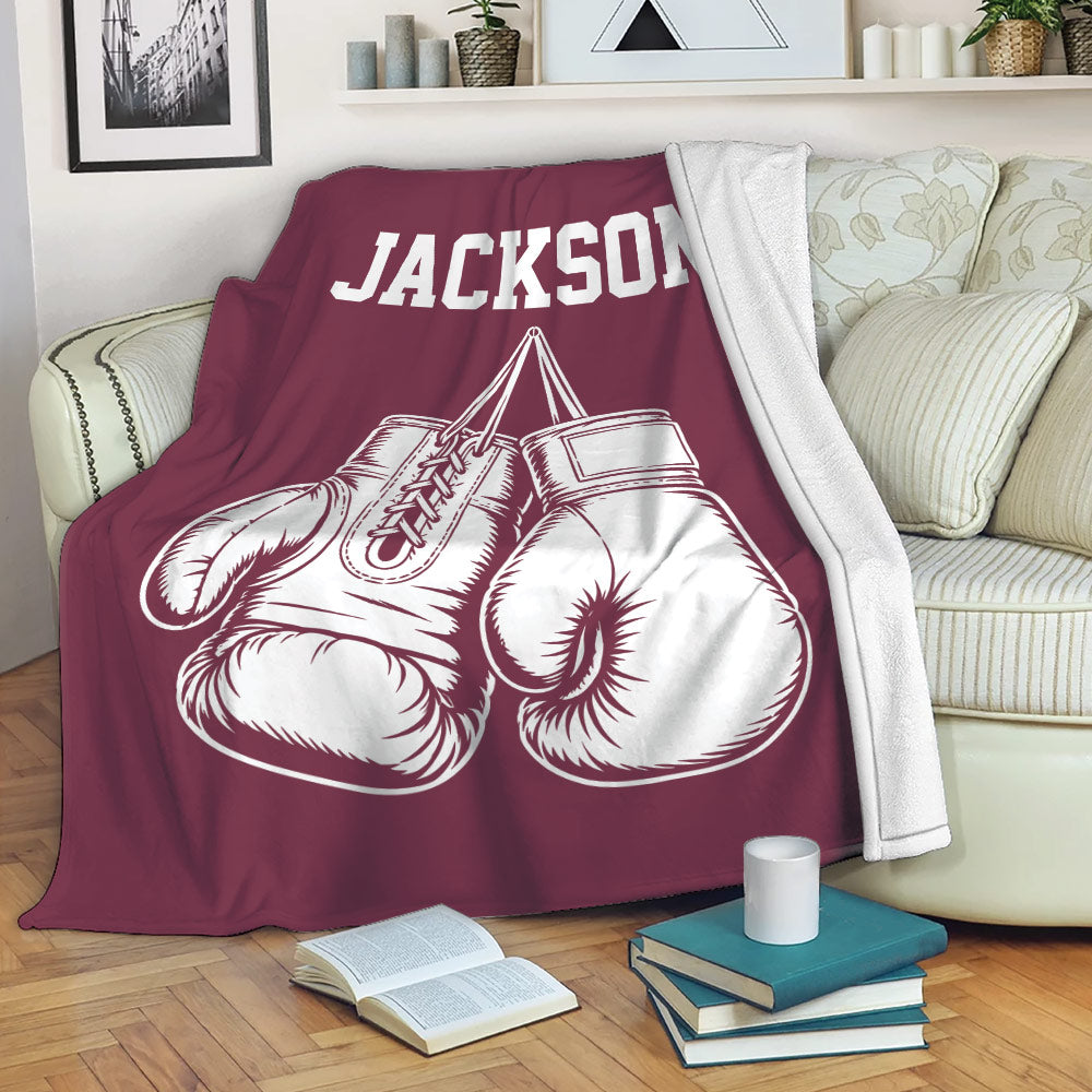Boxing throw blanket draped over a sofa with illustrated gloves and bold sports artwork