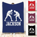 Wrestling throw blanket with two grappler silhouettes in white on a navy background