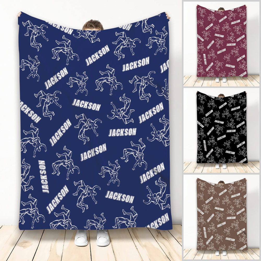 Wrestling throw blanket displayed in blue with repeating grappling silhouettes and custom-style lettering