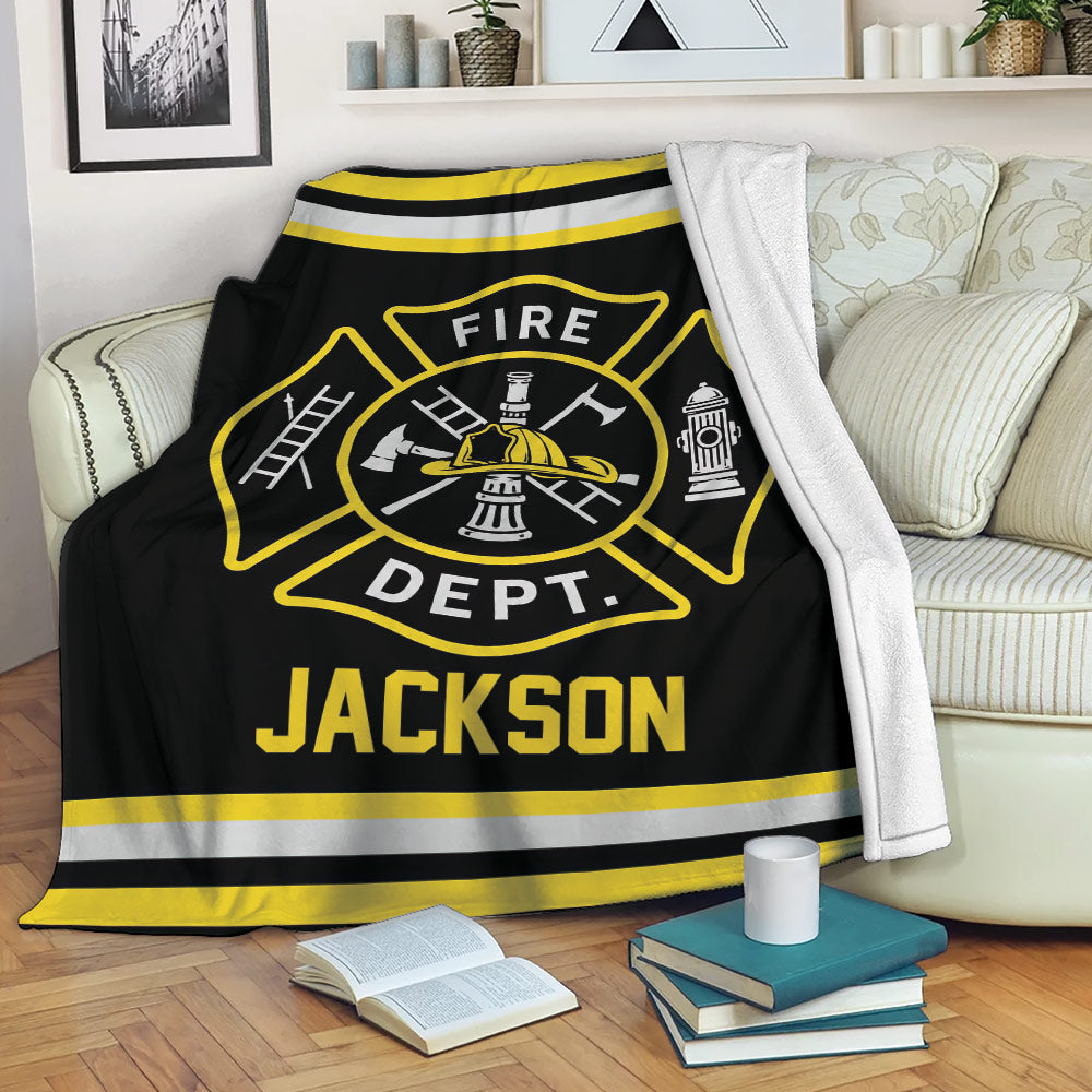 Firefighter throw blanket draped over a sofa with bold fire service emblem artwork