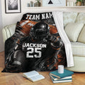 American football throw blanket displayed on a sofa with helmeted player artwork and bold sports graphics