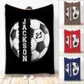 Custom soccer throw blanket showing split soccer ball artwork in black, brown, red, and blue color options