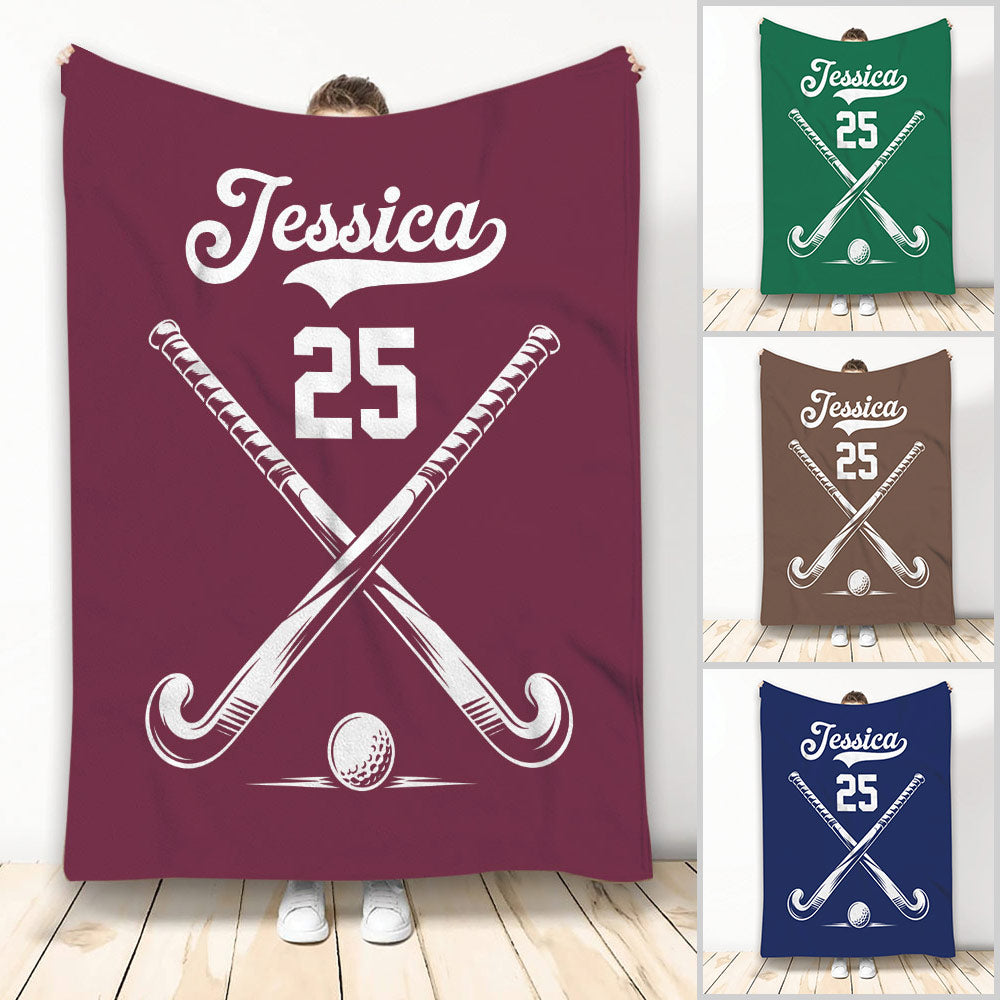 Custom hockey blanket design shown in multiple colors with crossed sticks and a hockey ball