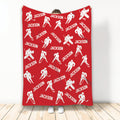 Red hockey throw blanket featuring repeating white ice hockey player silhouettes