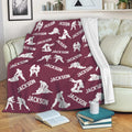 Jiu Jitsu throw blanket draped over a sofa with repeating grappling artwork in a deep maroon color