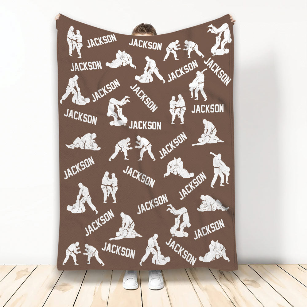 Brown Jiu Jitsu blanket displaying repeating white grappling silhouettes and bold custom design elements