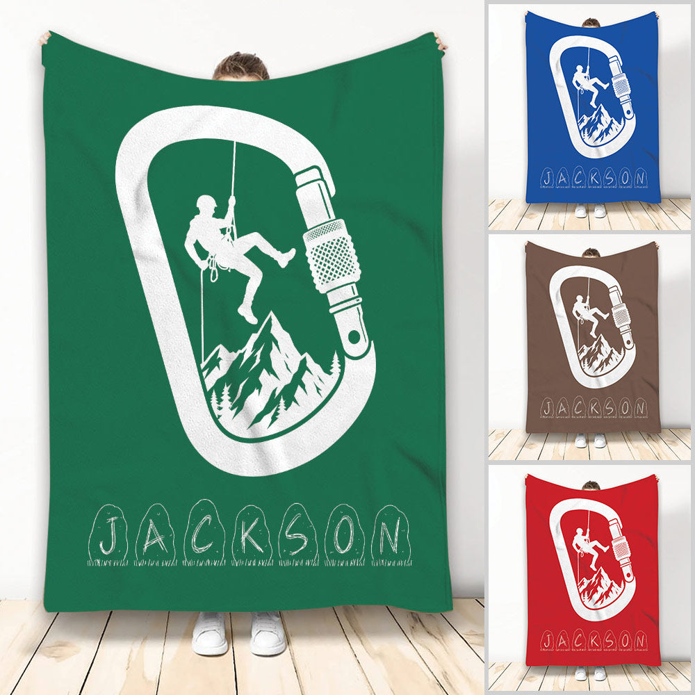 Green rock climbing blanket featuring a climber, rope, carabiner, mountain artwork, and custom design