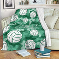 Green camouflage volleyball blanket styled over a sofa with repeating volleyball artwork