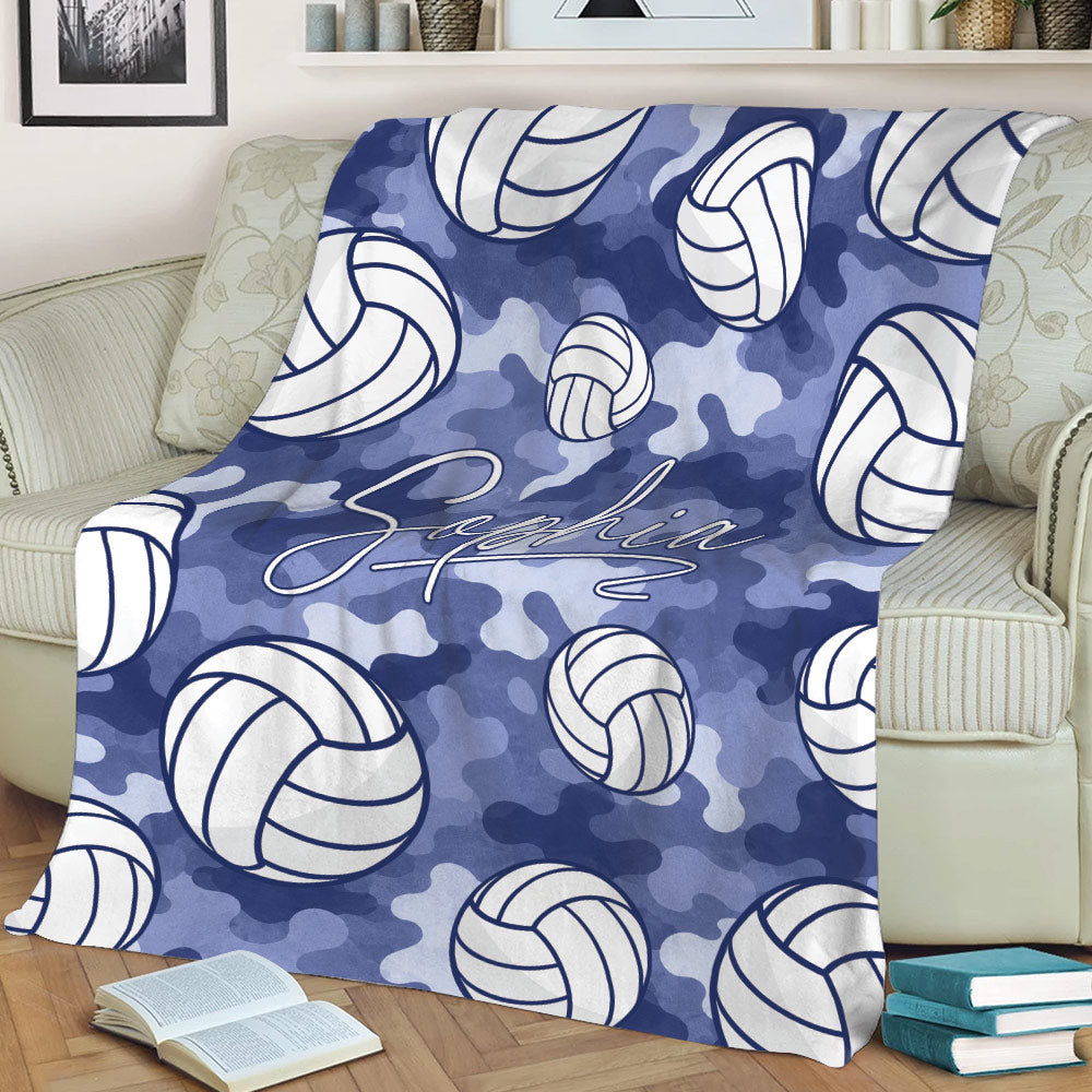 Blue camouflage volleyball blanket draped over a sofa with repeating volleyball artwork