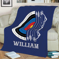 Navy archery blanket spread across a sofa with large target, bow, and arrow artwork