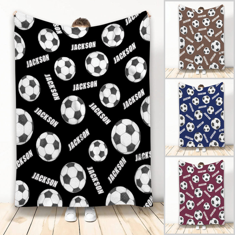Soccer blanket displayed with repeating black and white soccer balls in multiple color variations