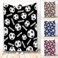 Soccer blanket displayed with repeating black and white soccer balls in multiple color variations