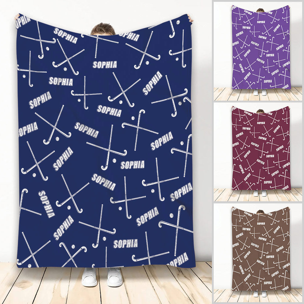 Hockey throw blanket with crossed sticks and pucks in a repeating navy, purple, maroon, and brown design