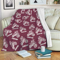 Maroon motocross throw blanket displayed on a sofa with repeated dirt bike rider artwork