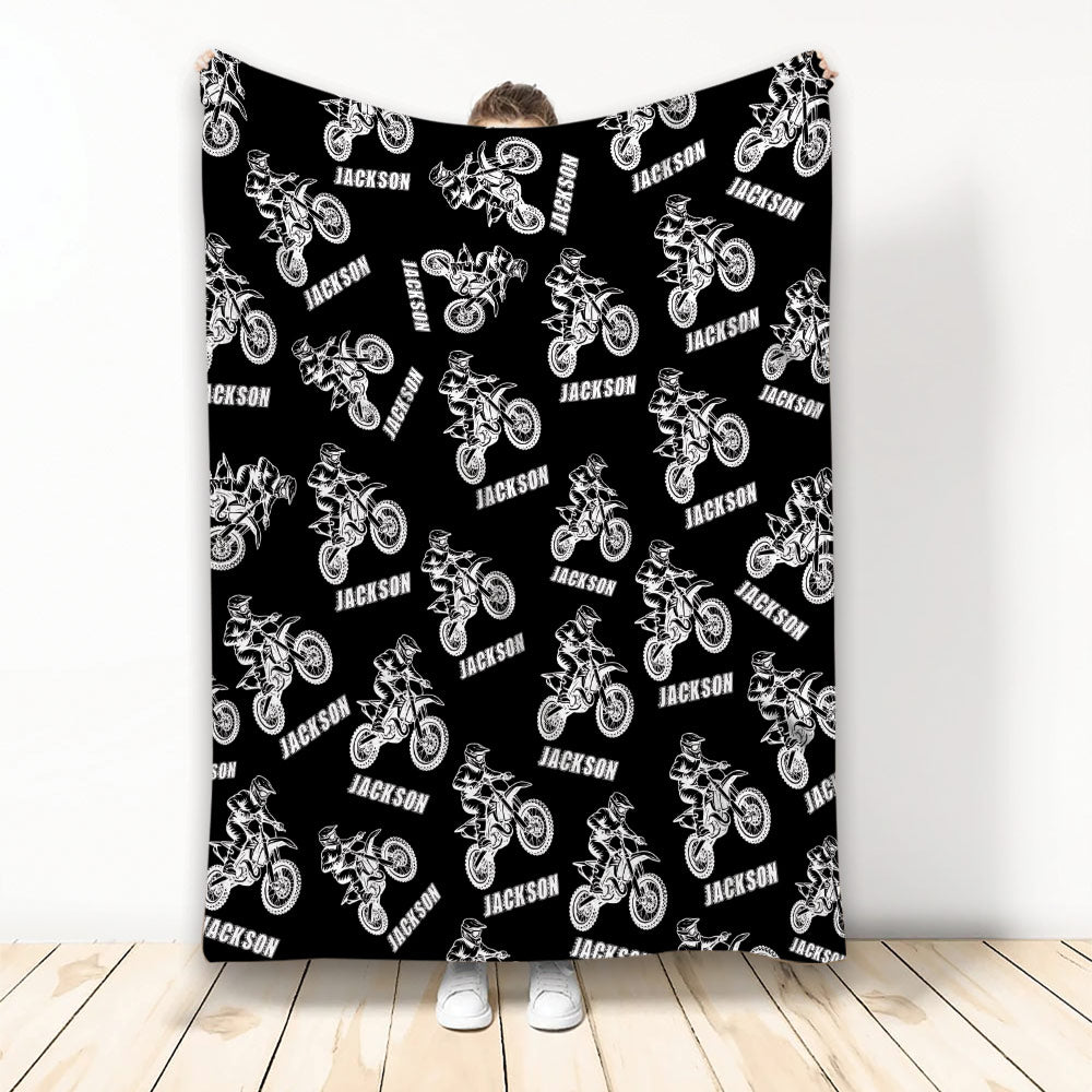 Black motocross throw blanket featuring a repeating white dirt bike rider pattern