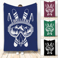 Custom skiing blanket with crossed skis, ski goggles, poles, and mountain artwork in multiple colors