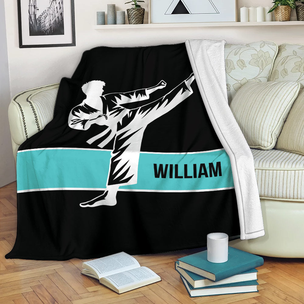 Black karate blanket featuring a dynamic martial arts kick and contrasting turquoise stripe