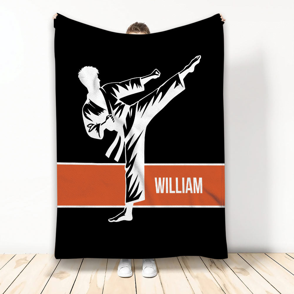 Karate blanket displayed upright with a high-kicking martial artist silhouette and bold orange stripe