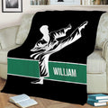 Karate throw blanket styled on a sofa with a dramatic martial artist silhouette and green accent stripe