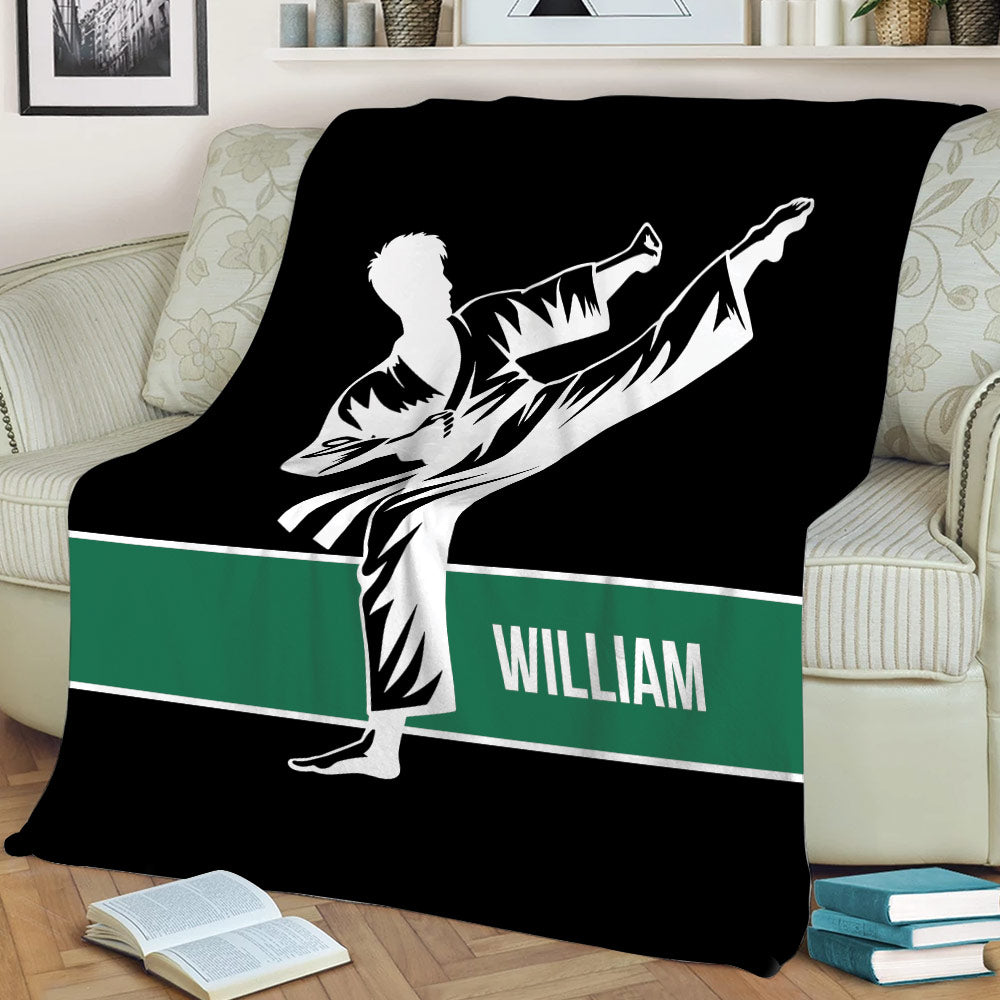 Karate throw blanket styled on a sofa with a dramatic martial artist silhouette and green accent stripe