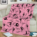 Pink gymnastics throw blanket with black gymnast silhouettes displayed on a sofa