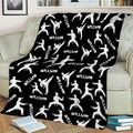 Black Taekwondo throw blanket with white kicking and sparring silhouettes on a couch