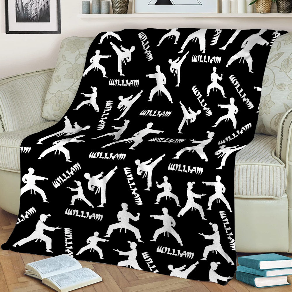 Black Taekwondo throw blanket with white kicking and sparring silhouettes on a couch